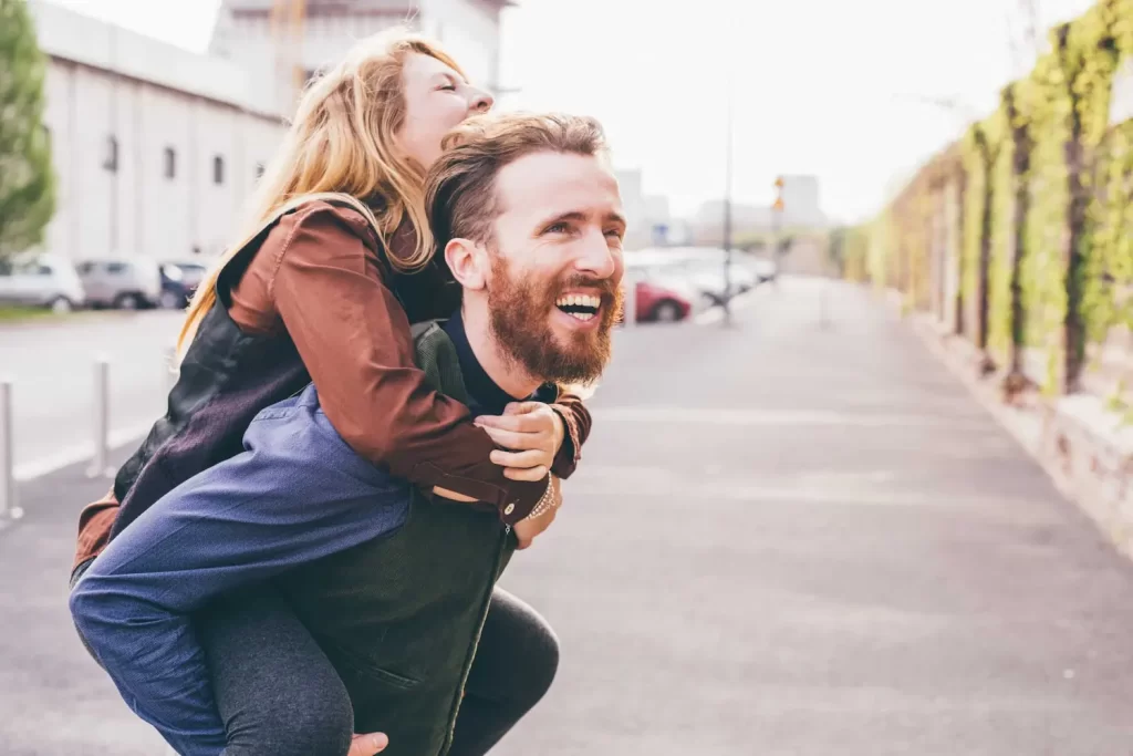 young-couple-hugging-outdoor-smiling